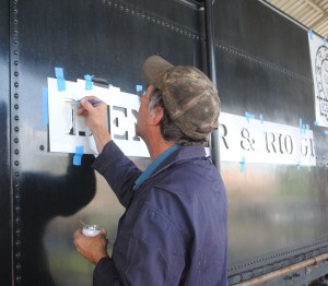 Lee Connor applies new lettering to the tender.